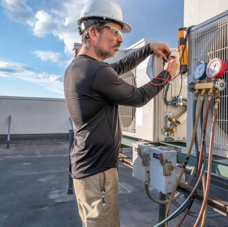 Technician servicing a commercial HVAC system in Sparks, Nevada