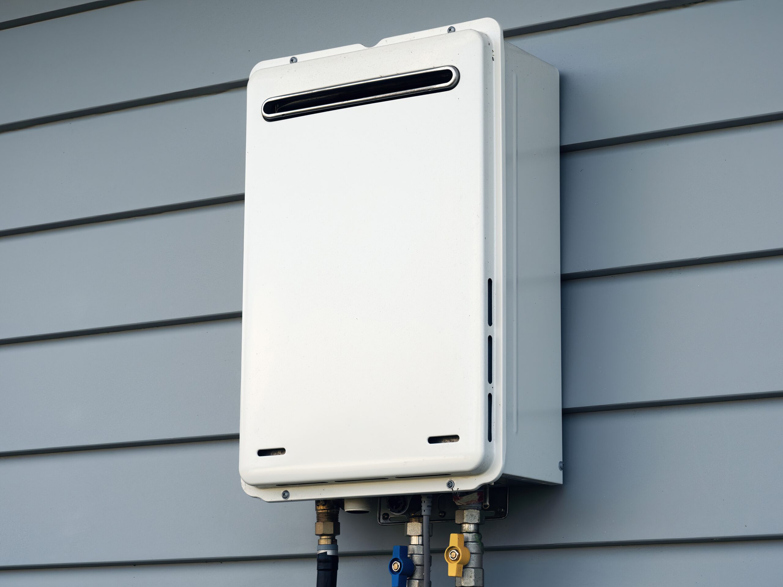 White exterior tankless water heater on wall