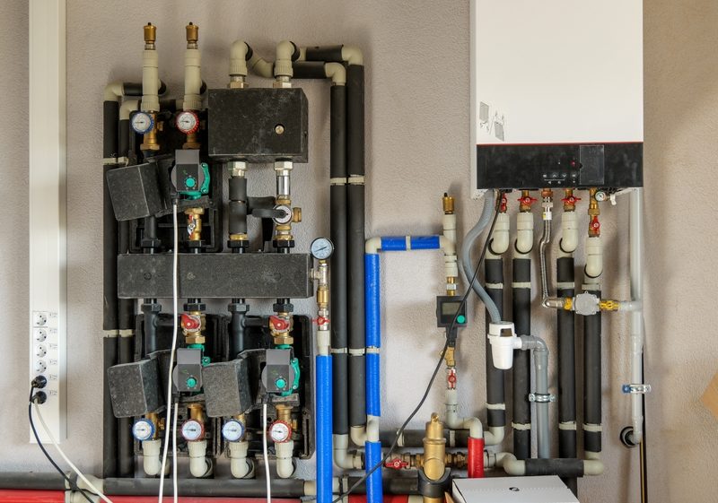Detailed plumbing installation with various valves and gauges.